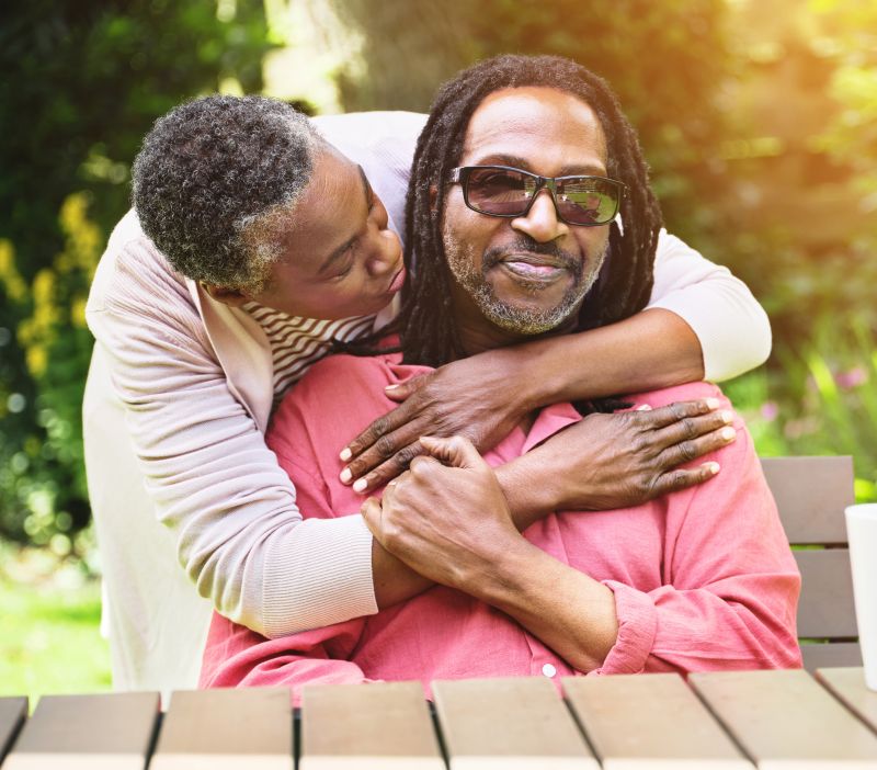 two adults embracing outside in a hug
